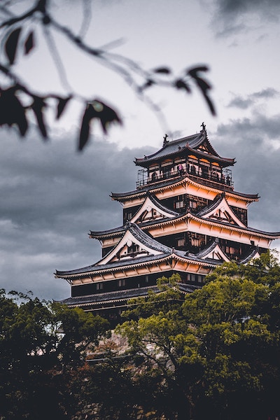 tall, angular Japanese building with people looking out from top floor