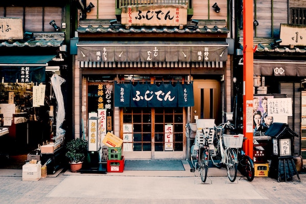 Japanese store front with bicycles and posters outside