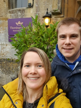 Couple standing outside the entrance to Thornbury Castle after winning a Weekender prize in our Weekly Draw