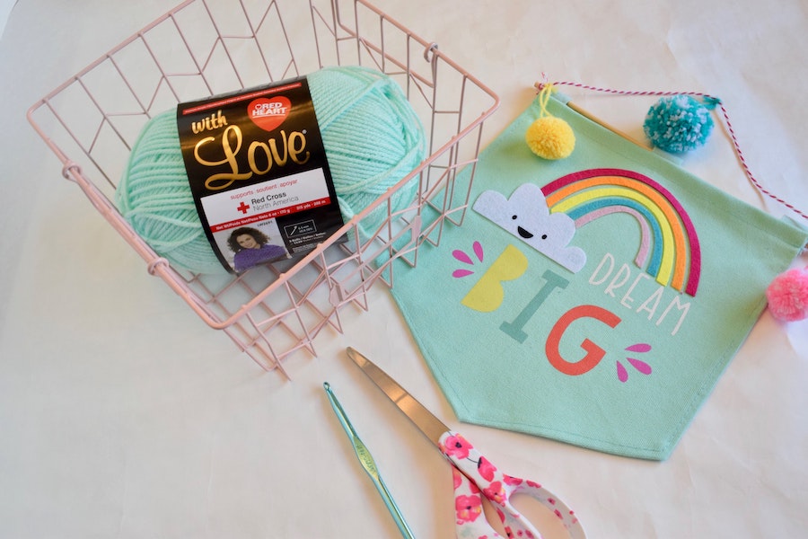 Art and crafts basket with scissors, needle, and lightly coloured thread
