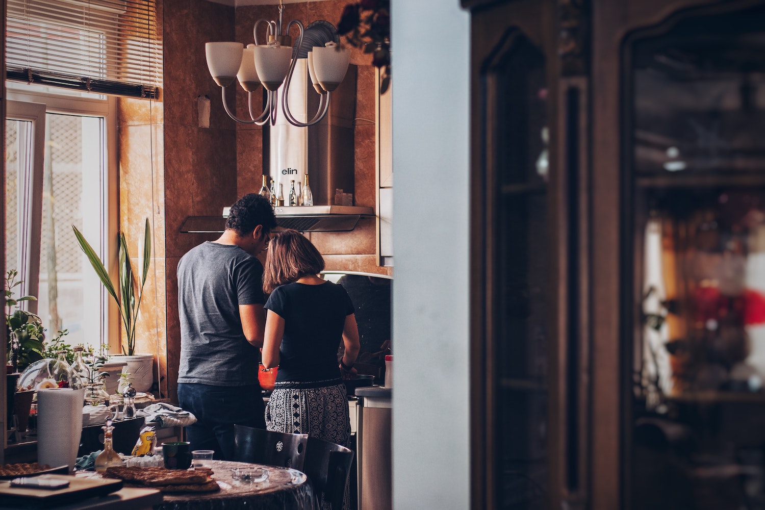 couple cooking together in their home kichen